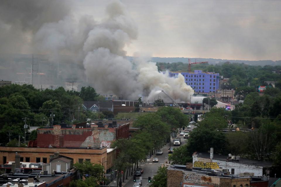 Plumes of smoke rise into the sky in the aftermath of a protest after a white police officer was caught on a bystander's video pressing his knee into the neck of African-American man George Floyd, who later died at a hospital, in Minneapolis, Minnesota, U.S., May 29, 2020. REUTERS/Carlos Barria