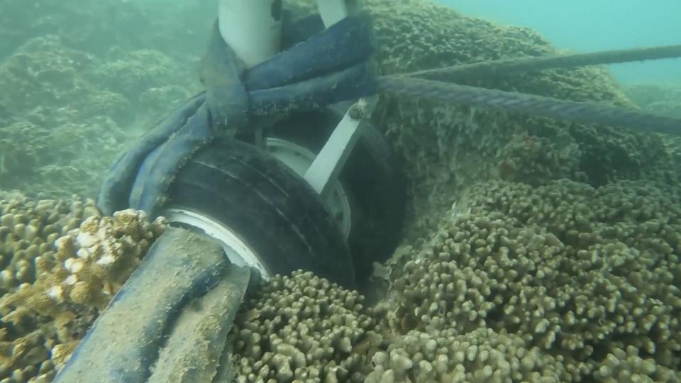 In this image taken from video provided by the U.S. Navy, Navy divers assigned to Mobile Diving and Salvage Unit One conduct an underwater survey of the U.S. Navy's P-8A Poseidon in Kaneohe Bay, Hawaii, on Tuesday, Nov. 28, 2023. (U.S. Navy via AP)