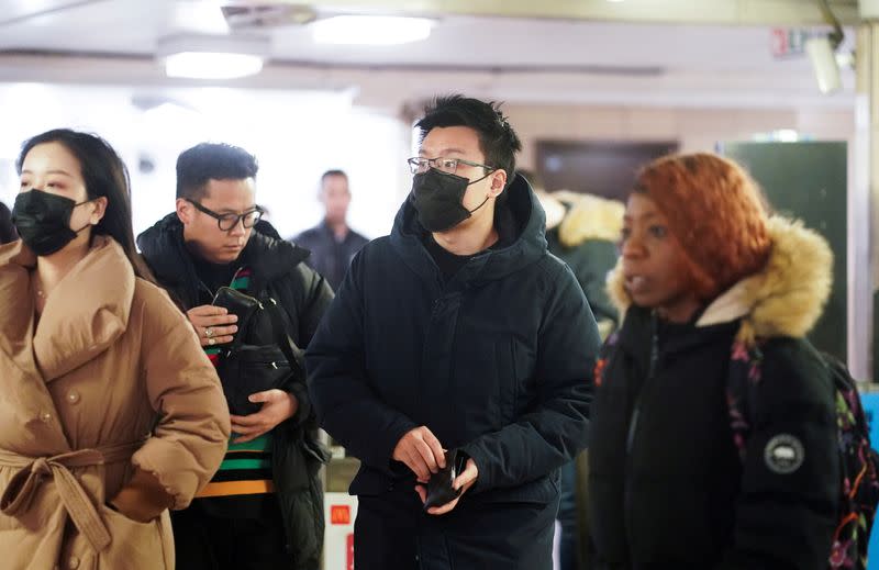 People wear protective face masks at the London Underground in central London