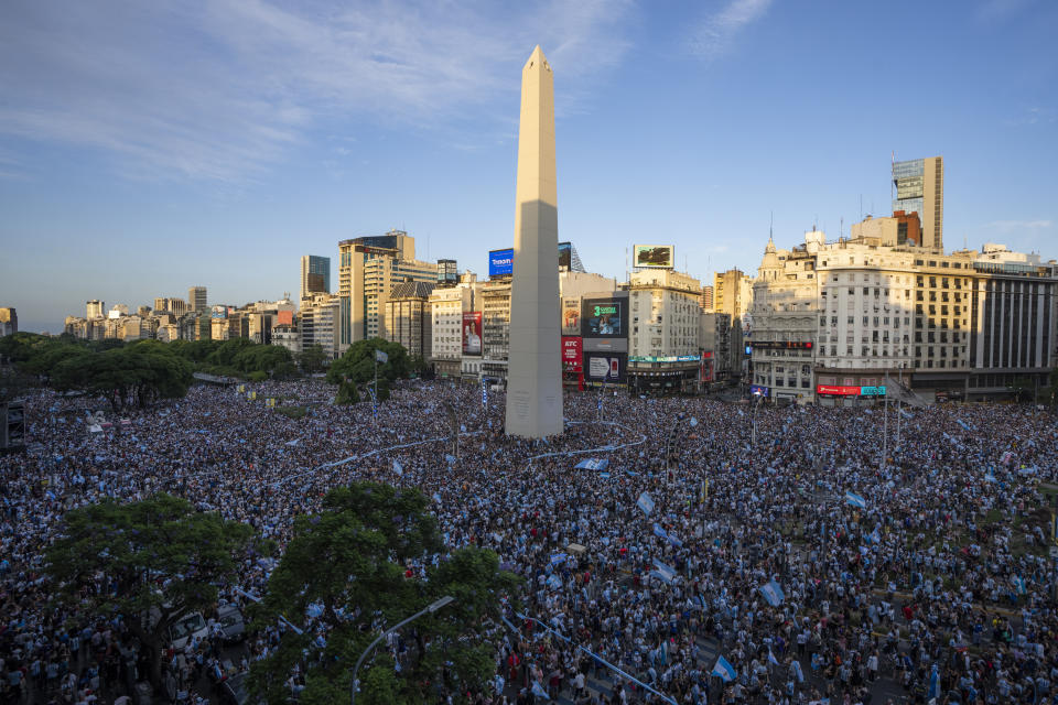 Argentina soccer fans celebrate their team's victory over Croatia in a World Cup semifinal match, by the Obelisk in downtown Buenos Aires, Argentina, Tuesday, Dec. 13, 2022. (AP Photo/Victor R. Caivano)