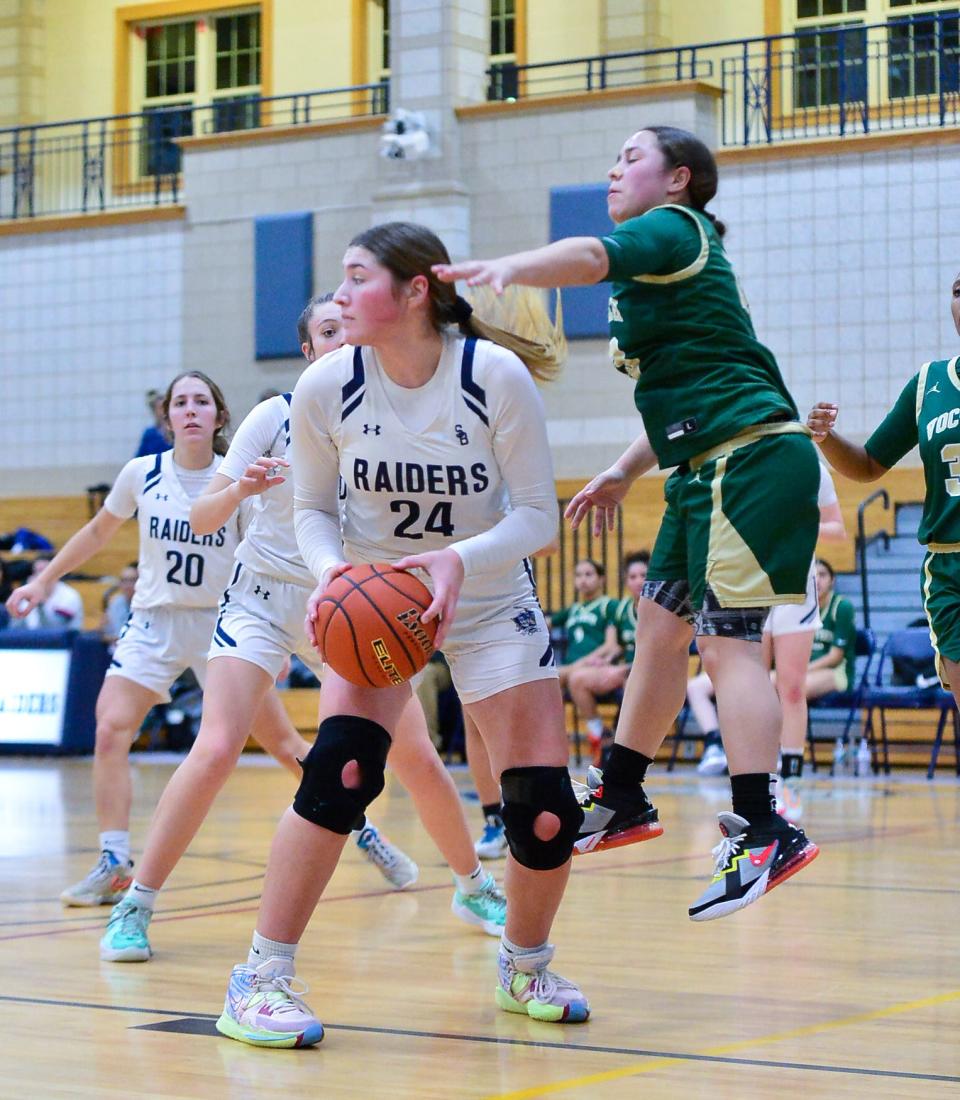 Somerset Berkley’s Gabriella Nugent looks to make a play while being guarded by New Bedford Voc’s Casalice Dias.