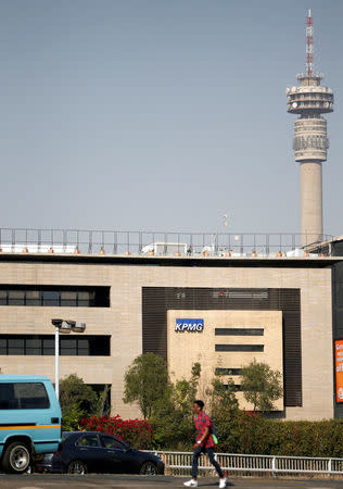 A man walks past the KPMG company head offices in Parktown, Johannesburg, South Africa, September 15, 2017. REUTERS/Siphiwe Sibeko