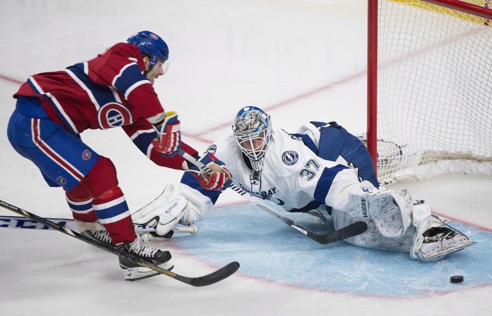 Tampa Bay Lightning's goaltender Kristers Gudlevskis makes a save against Montreal Canadiens' Max Pacioretty during third period NHL Stanley Cup playoff action in Montreal, Tuesday, April 22, 2014. (AP Photo/The Canadian Press, Graham Hughes)