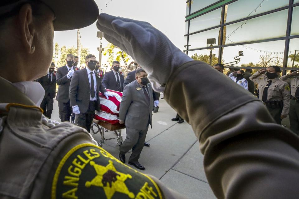 Pallbearers carry the casket of Deputy Thomas Albanese