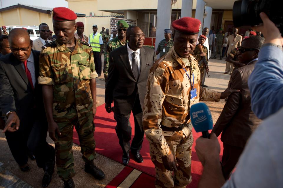 Central African Republic President Michel Djotodia, center, arrives at Mpoko Airport to board a plane to Chad, in Bangui, Central African Republic, Wednesday, Jan. 8, 2014. The embattled president, who has come under growing pressure to resign, traveled to neighboring Chad on Wednesday for a summit with regional leaders who want to end the bloodshed that has left more than 1,000 dead and nearly a million people displaced. (AP Photo / Rebecca Blackwell)