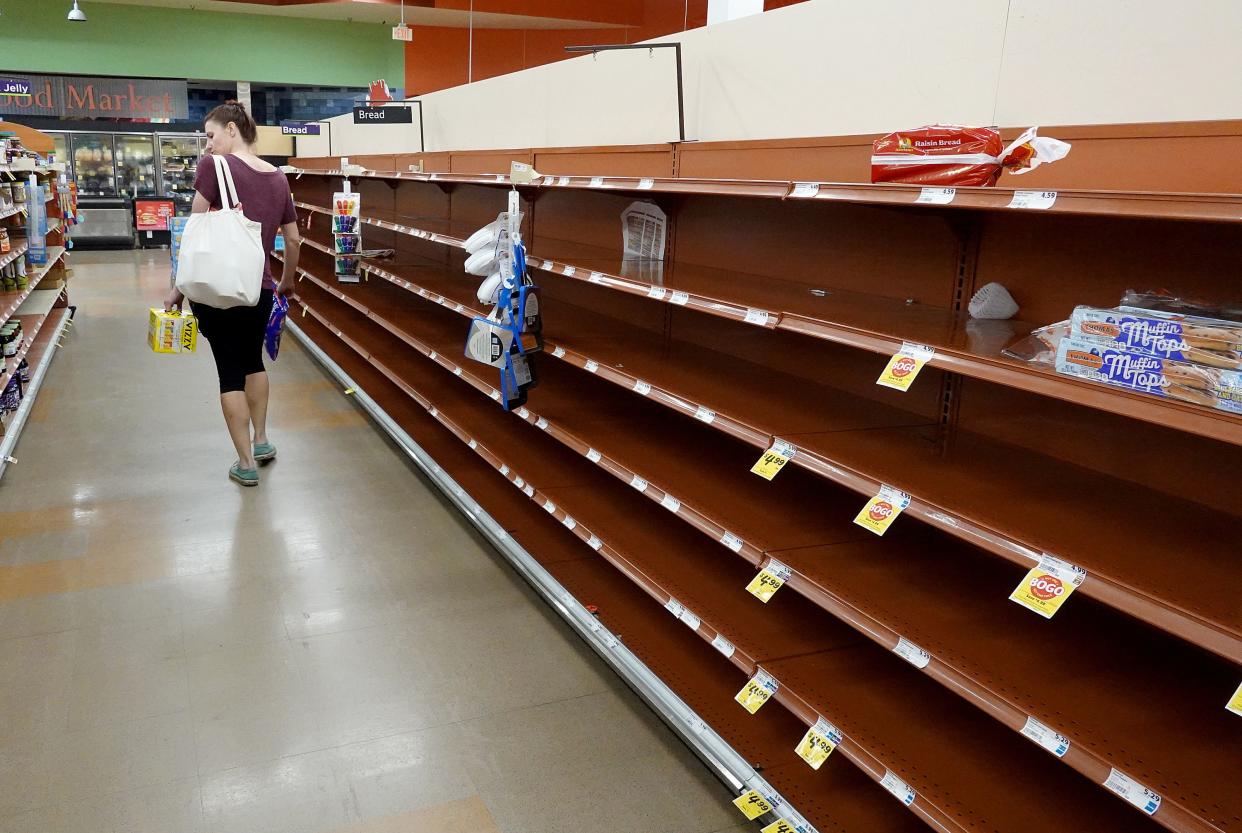 Shelves in the bread aisle stand empty as residents prepare for Hurricane Ian on Sept. 26, 2022, in St Petersburg, Fla.