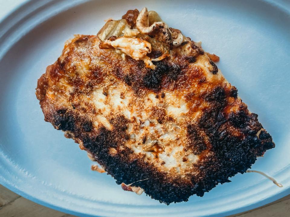 Burned piece of lasagna on a plate