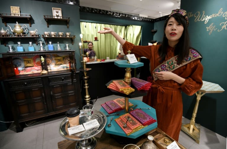 A sales clerk at the Japanese chocolate shop Kloka invites customers to a temporary booth set up for Valentine's Day at a department store in the Ginza shopping district in Tokyo