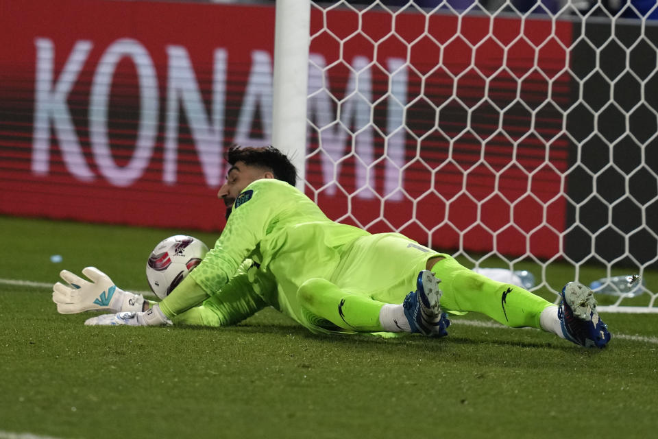 Iran's goalkeeper Ali Reza Safarbeiranvand saves during a penalty kick shoot-out during the Asian Cup round of 16 soccer match between Syria and Iran at Abdullah Bin Khalifa Stadium in Doha, Qatar, Wednesday, Jan. 31, 2024. (AP Photo/Thanassis Stavrakis)