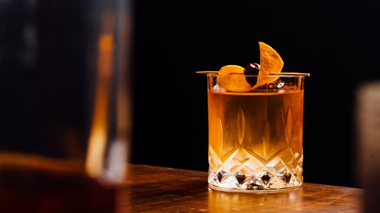 old fashioned cocktail with orange garnish