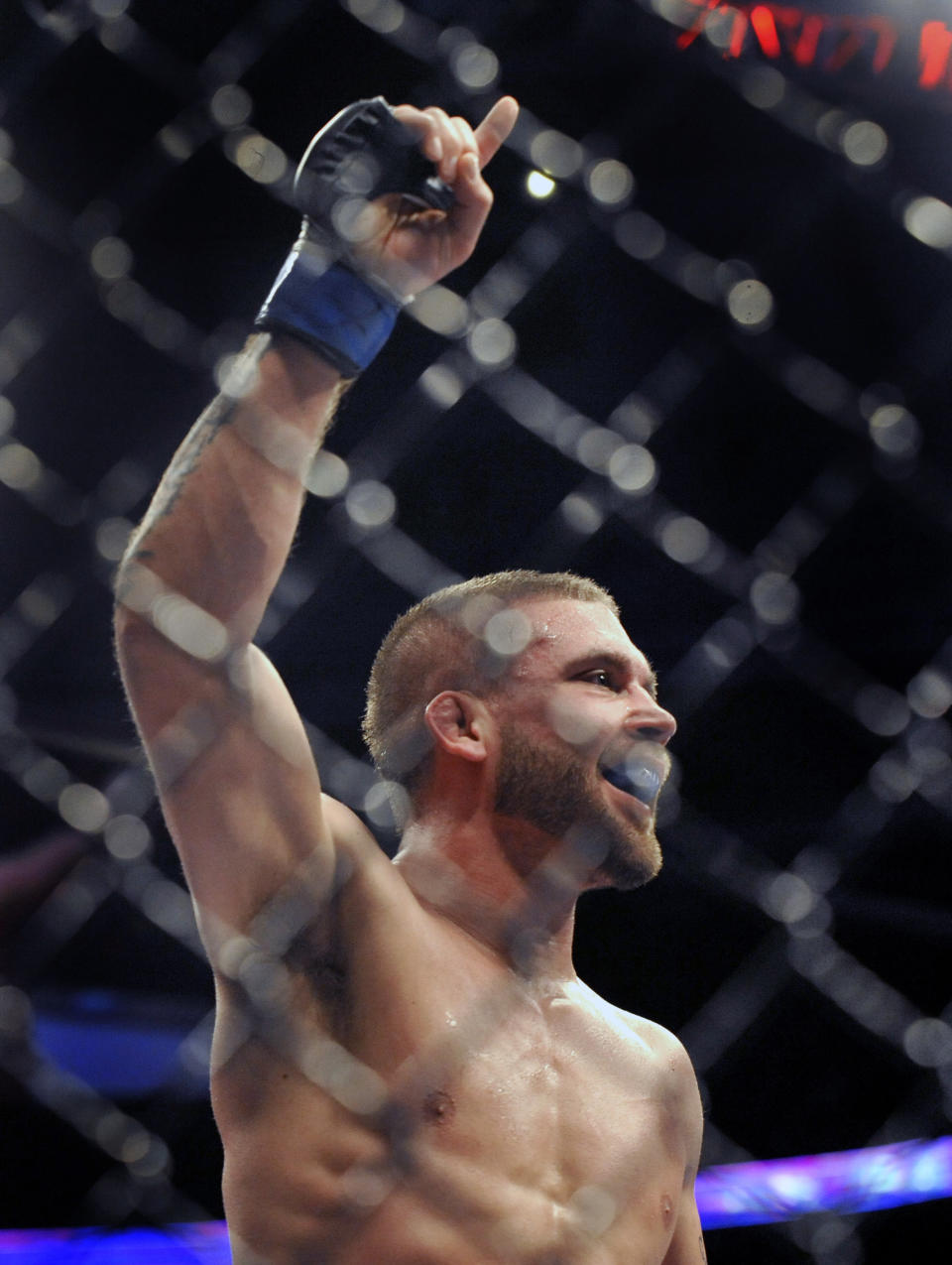 Jeremy Stephens celebrates after defeating Darren Elkins during the featherweight bout of an UFC mixed martial arts match in Chicago, Saturday, Jan., 25, 2014. (AP Photo/Paul Beaty)