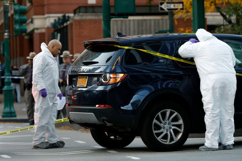 NEW YORK, NY - OCTOBER 31: Investigators check a car on West Side Highway near the scene where a truck plowed through a bike path in lower Manhattan on October 31, 2017 in New York City. Officials are reporting up to 6 dead and 15 people have been injured.(Photo by Carolyn Cole/Los Angeles Times via Getty Images)