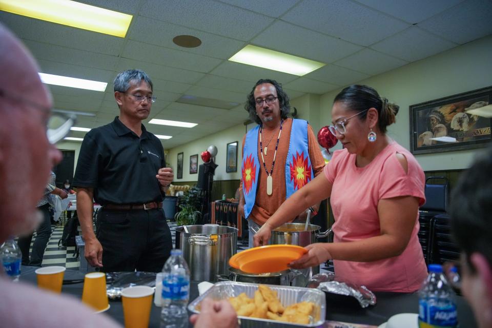 Hiro Kawamura, Ty Smith and Masai Smith serve homemake goodies to a tour group of Japanese citizens during the last stop of their journey around Columbus. The tour was part of the Japan-America Grassroots Summit.