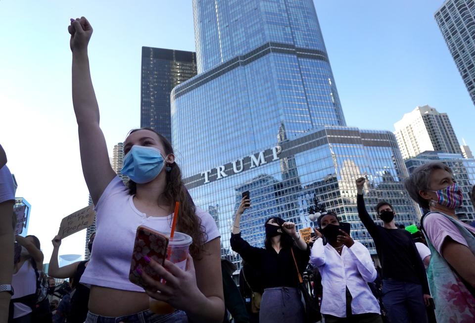 A group of people celebrate Joe Biden's 2020 presidential victory in front of Trump Tower in Chicago.