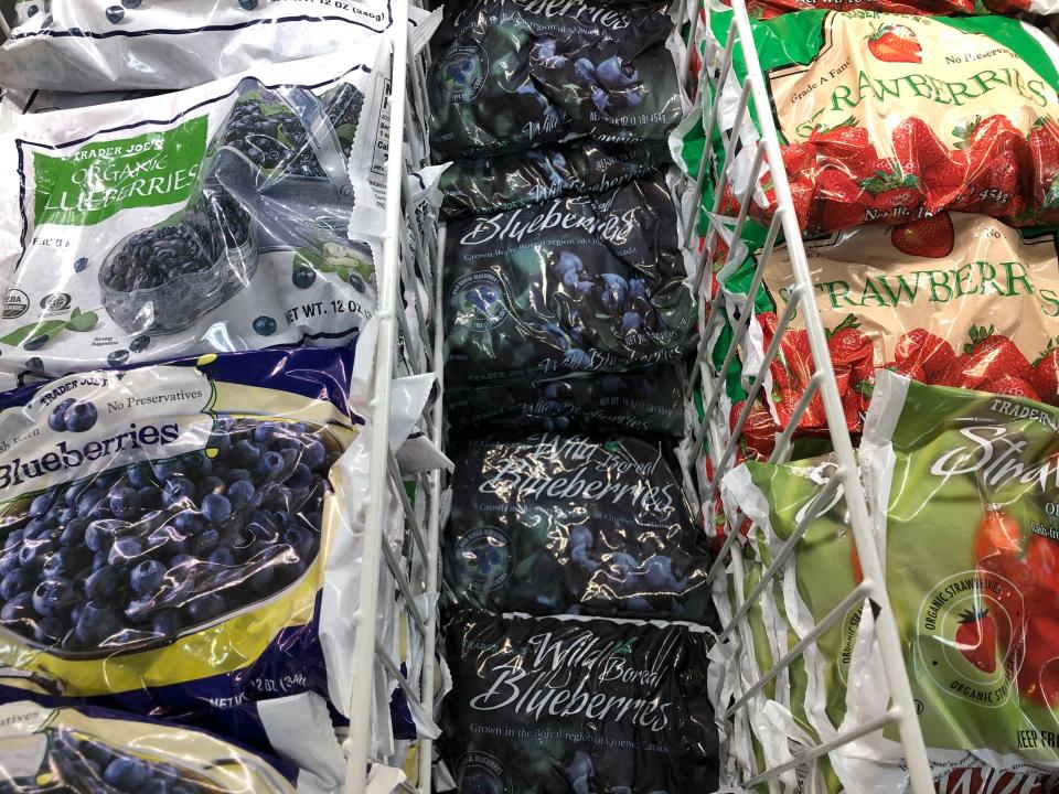 Bags of frozen fruit, including wild blueberries, on display at Trader Joe's.