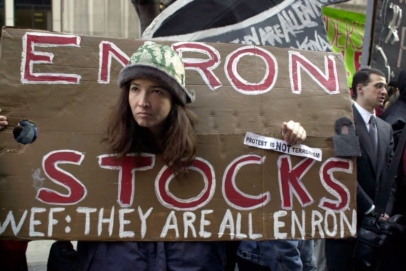 Protesters targeting the World Economic Forum meetings in New York City demonstrate on February 4, 2002, outside the New York branch offices of Arthur Anderson Accounting, the firm that handled the ledgers of Enron. On February 2, 2002, a report requested by the board of directors of the Enron Corp. accused top executives of forcing the company into bankruptcy by, among other things, inflating profits by almost $1 billion. File Photo by Ezio Petersen/UPI