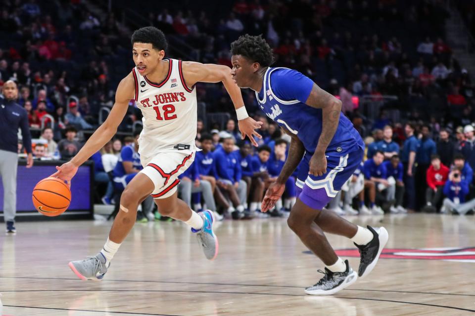 St. John's Red Storm guard RJ Luis Jr. (12) looks to drive past Seton Hall Pirates guard Kadary Richmond (1) in the second half at UBS Arena.