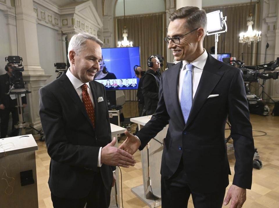 The two candidates with the most preliminary votes, National Coalition Party candidate Alexander Stubb, right, and Social Movement candidate Pekka Haavisto shake hands during a Presidential election event, at the Helsinki City Hall, in Helsinki, Finland, Sunday, Jan. 28, 2024. A projection in Finland says Alexander Stubb has won the first round of the presidential election to set up a Feb 11 runoff. ((Markku Ulander/Lehtikuva via AP)