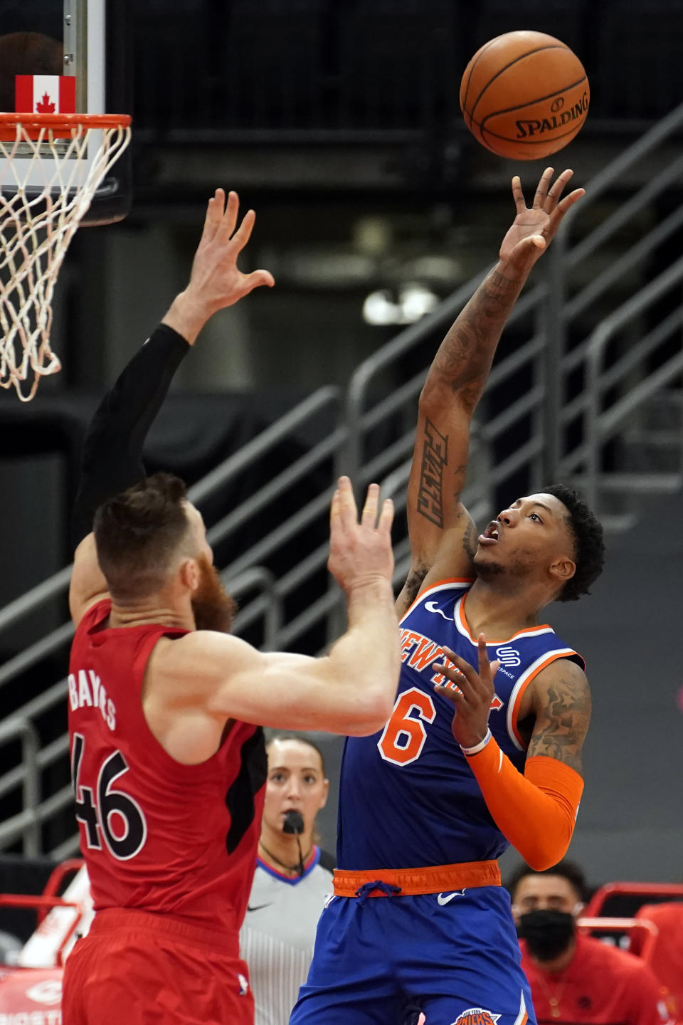 New York Knicks guard Elfrid Payton (6) shoots over Toronto Raptors center Aron Baynes (46) during the second half of an NBA basketball game Thursday, Dec. 31, 2020, in Tampa, Fla. (AP Photo/Chris O'Meara)