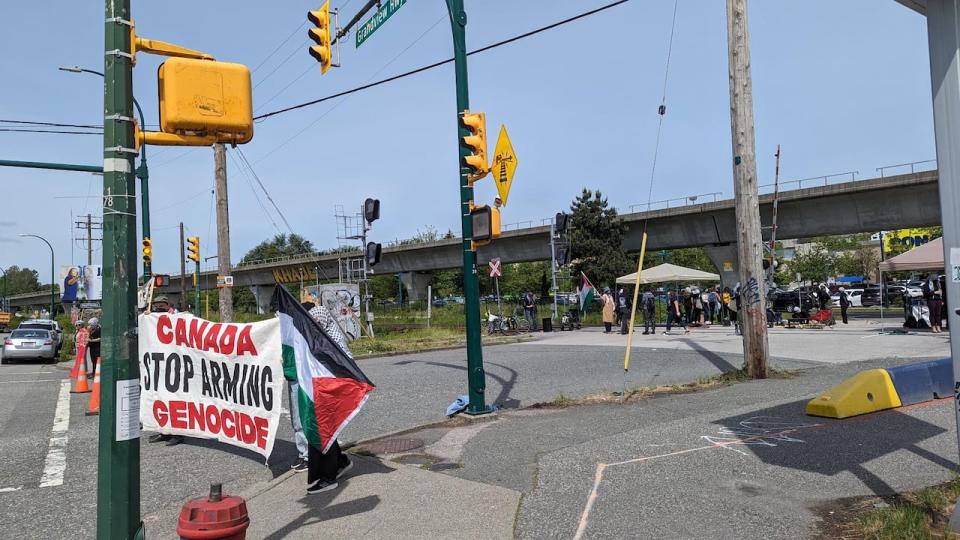 In this submitted photo from protesters, members of a Friday rally can be seen in East Vancouver calling for Canada to impose sanctions on Israel in response to ongoing action in Gaza.