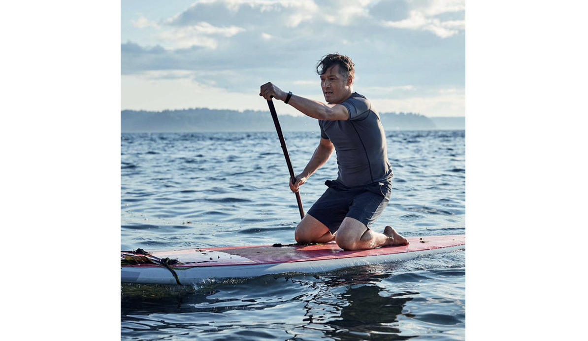 Man wearing Halo tracker on a paddleboard.