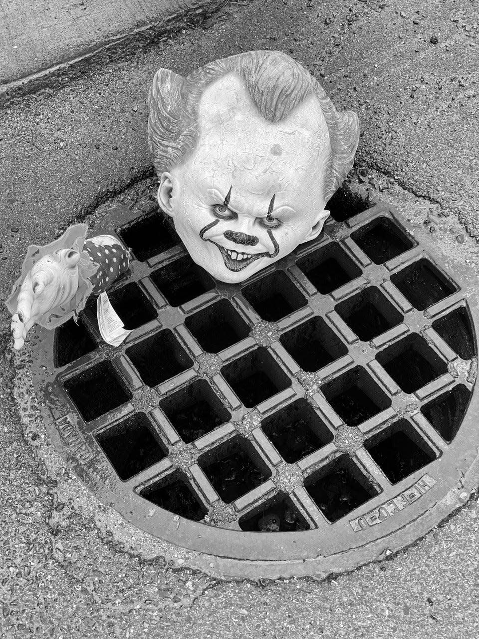 Pennywise the Clown, the central monster in Stephen King's 1986 novel "It," taunts passersby from a sewer grate in Bangor, Maine. Author Sharon Kitchens visited the spot and snapped this picture for her new book, "Stephen King's Maine."