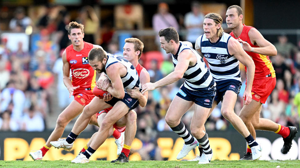 Geelong and Gold Coast Suns players contest the ball during their round three AFL match.