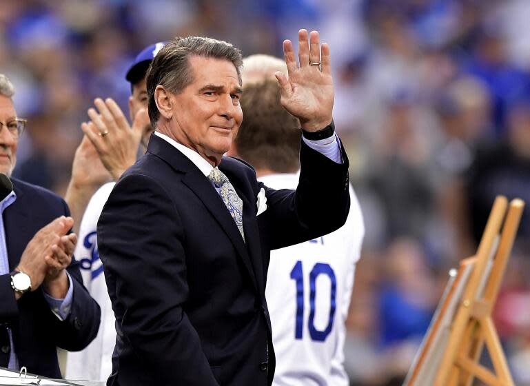 Former Dodger Steve Garvey waves to fans prior to a baseball game on Saturday, June 1, 2019, in Los Angeles.