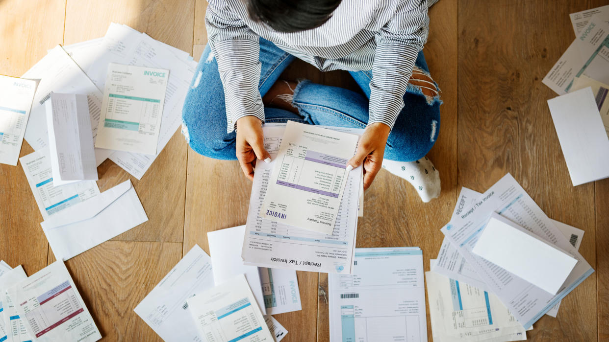 woman reviewing her personal finance paperwork