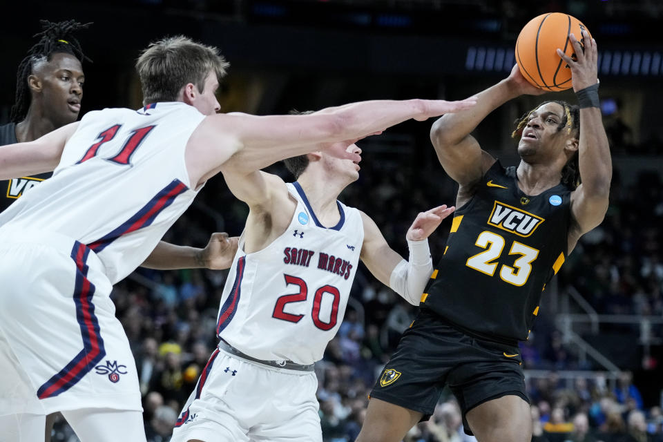 Virginia Commonwealth's Jayden Nunn (23) shoots against St. Mary's Mitchell Saxen (11) in the first half of a first-round college basketball game in the NCAA Tournament, Friday, March 17, 2023, in Albany, N.Y. (AP Photo/John Minchillo)