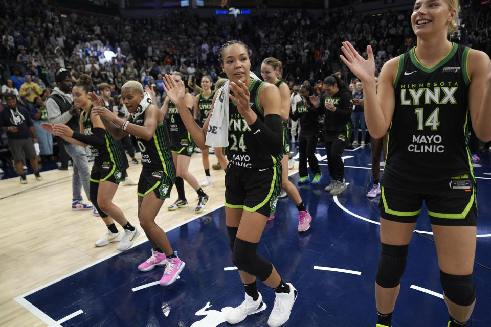 Minnesota Lynx forward Napheesa Collier (24) celebrates with teammates after the 88-77 win against the Connecticut Sun of Game 5 of a WNBA basketball semifinals, Tuesday, Oct. 8, 2024, in Minneapolis. (AP Photo/Abbie Parr)