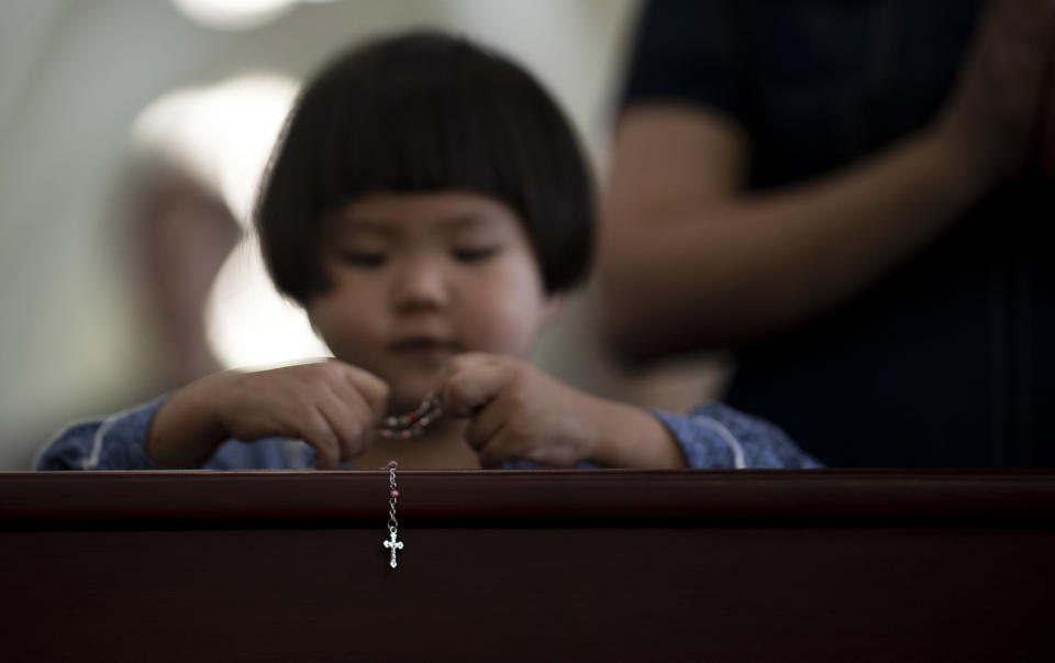 A young Catholic attends a mass at the government-sanctioned St. Ignatius Catholic Cathedral in Shanghai on September 30, 2018. - China and the Vatican signed a provisional agreement on September 22 on who gets to name senior churchmen, an issue that has bedevilled ties for decades, and China quickly said it hoped for an improvement in relations. (Photo by Johannes EISELE / AFP)        (Photo credit should read JOHANNES EISELE/AFP/Getty Images)