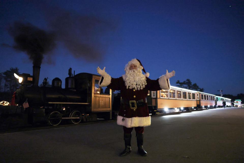 Santa arrives on a train during Edaville's Christmas Festival of Lights on Thursday, Nov. 19, 2022 at Edaville Family Theme Park in Carver. 