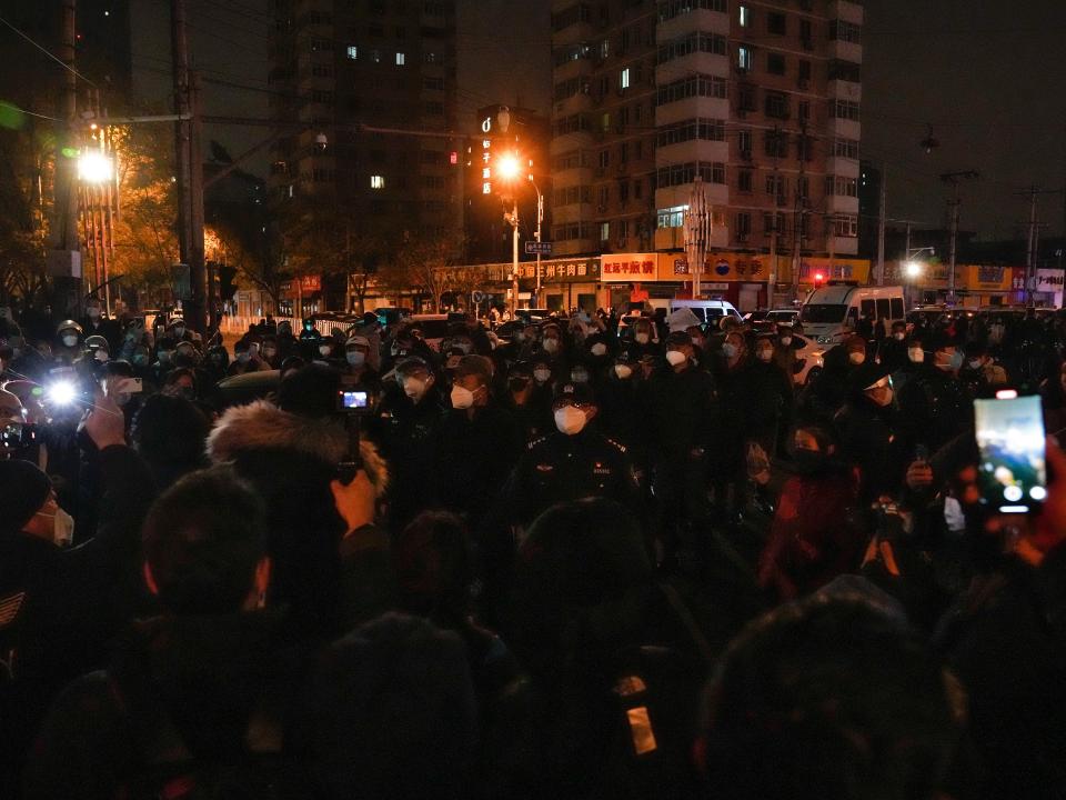 Protesters clash with policemen during a protest in Beijing, Sunday, Nov. 27, 2022.