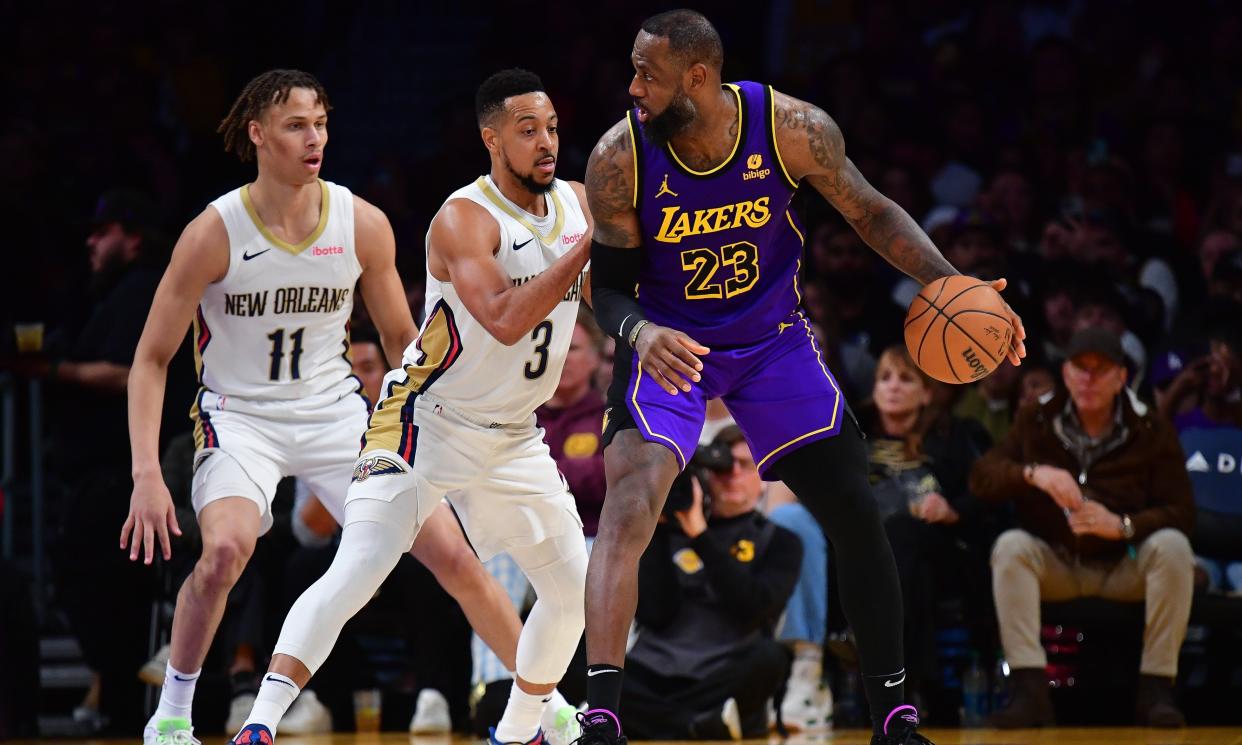 Feb 9, 2024; Los Angeles, California, USA; Los Angeles Lakers forward LeBron James (23) moves the ball against New Orleans Pelicans guard CJ McCollum (3) and guard Dyson Daniels (11) during the second half at Crypto.com Arena. Mandatory Credit: Gary A. Vasquez-USA TODAY Sports
