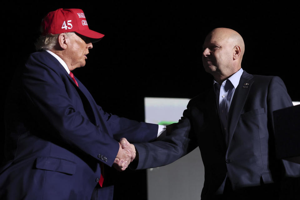 Pennsylvania Republican gubernatorial candidate Doug Mastriano shakes hands with former U.S. President Donald Trump during a rally at the Arnold Palmer Regional Airport November 5, 2022 in Latrobe, Pennsylvania.  / Credit: / Getty Images