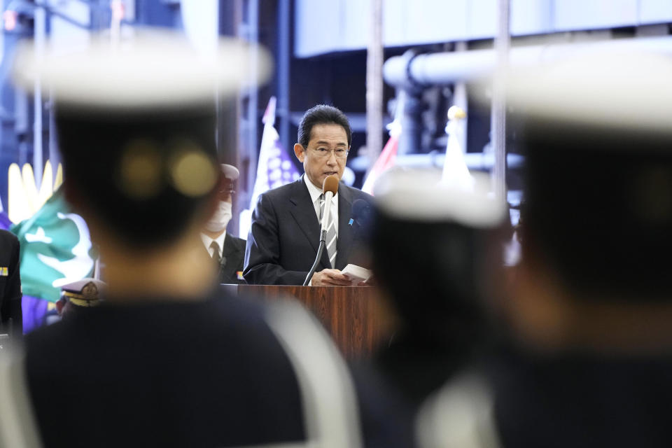 Japanese Prime Minister Fumio Kishida delivers a speech on the Maritime Self Defense Force's helicopter carrier JS Izumo during an international fleet review in Sagami Bay, southwest of Tokyo, Sunday, Nov. 6, 2022. Kishida, at an international fleet review Sunday, said his country urgently needs to build up military capabilities as it faces worsening security environment in the East and South China Seas and threats from North Korea’s nuclear and missile advancement and Russia’s war on Ukraine.(Kyodo News via AP)