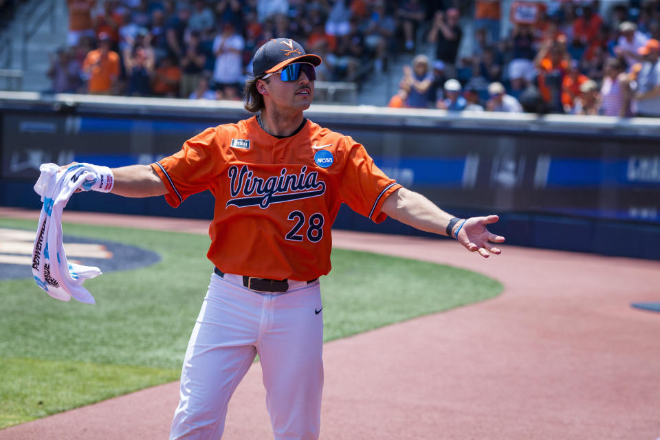 Virginia pitcher Nick Parker motivates fans during an NCAA college baseball tournament super regional game against Duke, Saturday, June 10, 2023, in Charlottesville, Va. (AP Photo/John C. Clark)