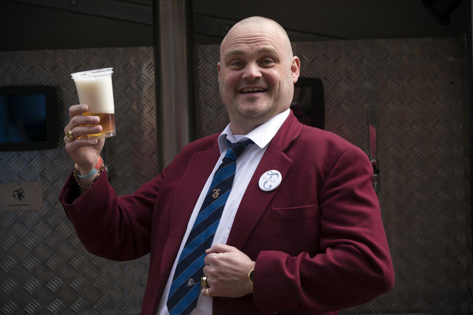 Alastair James Hay, better known as comedian 'Al Murray' who portrays an English pub landlord, poses with a pint of beer poured from a fire engine converted into a mobile pub after handing in his nomination papers at Thanet council offices on April 8, 2015 in Margate, England. Hay, in his comic guise of Al Murray is standing in the South Thanet seat against UKIP leader Nigel Farage.  (Photo by Carl Court/Getty Images)