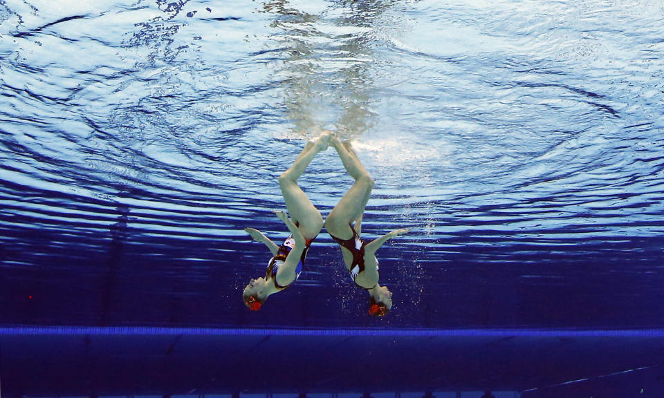 Natalia Ischenko and Svetlana Romanshina of Russia compete during women's duet synchronized swimming preliminary round at the Aquatics Centre in the Olympic Park during the 2012 Summer Olympics in London, Monday, Aug. 6, 2012. (AP Photo/Mark J. Terrill)