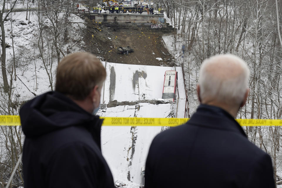 FILE - Vehicles that were on a bridge when it collapsed are visible as President Joe Biden visits the site where the Fern Hollow Bridge collapsed Jan. 28, 2022, in Pittsburgh's East End. The Fern Hollow Bridge became a symbol of the country's troubled infrastructure, collapsing into a ravine earlier this year just before President Joe Biden visited the city. Biden hopes to turn the bridge into a symbol of success for his administration when he returns to Pittsburgh on Thursday, Oct. 20, less than three weeks before the midterm elections. (AP Photo/Andrew Harnik, File)
