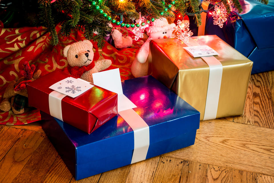 Wrapped presents and toys under a Christmas tree