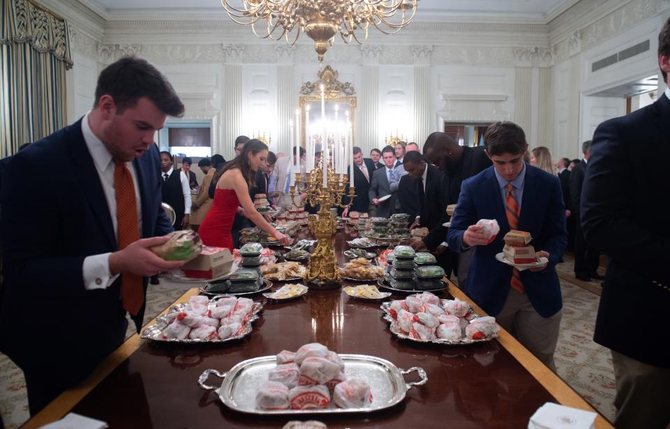 Guests select fast food that the US president purchased for a ceremony honoring the 2018 College Football Playoff National Champion Clemson Tigers in the State Dining Room of the White House in Washington, DC, January 14, 2019. – US President Donald Trump says the White House chefs are furloughed due to the partial government shutdown. (Photo: Saul Loeb/AFP/Getty Images)