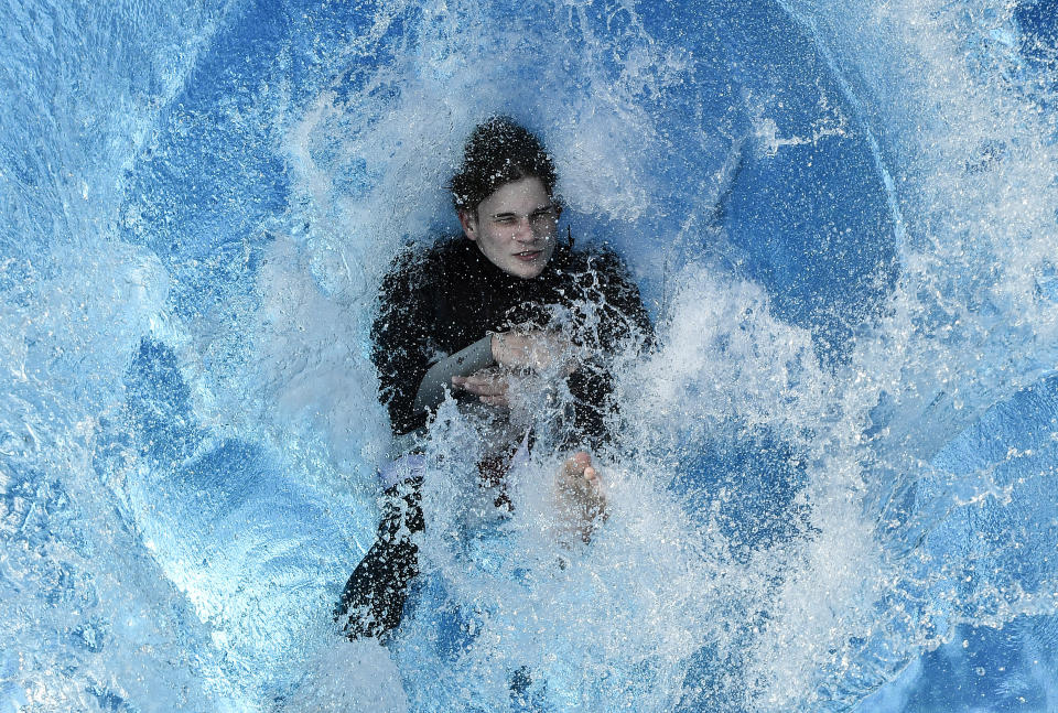 A swimmer jumps into the water during the opening day of the public open air pool in Cologne, Germany, on a warm and sunny Thursday, May 21, 2020. Public swimming pools in Germany are starting the summer season as the government is easing the coronavirus lockdown rules. (AP Photo/Martin Meissner)