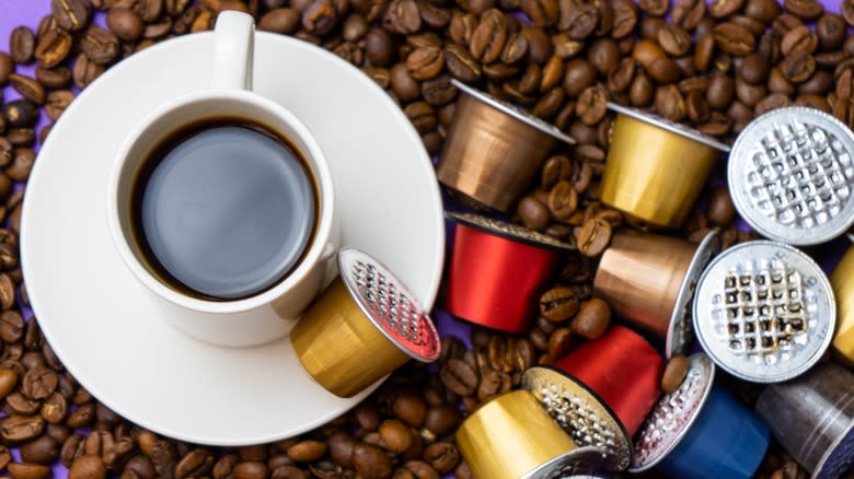 Nespresso pods with beans and coffee cup