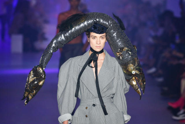 Model walks the Vivienne Westwood runway in a giant fish hat at