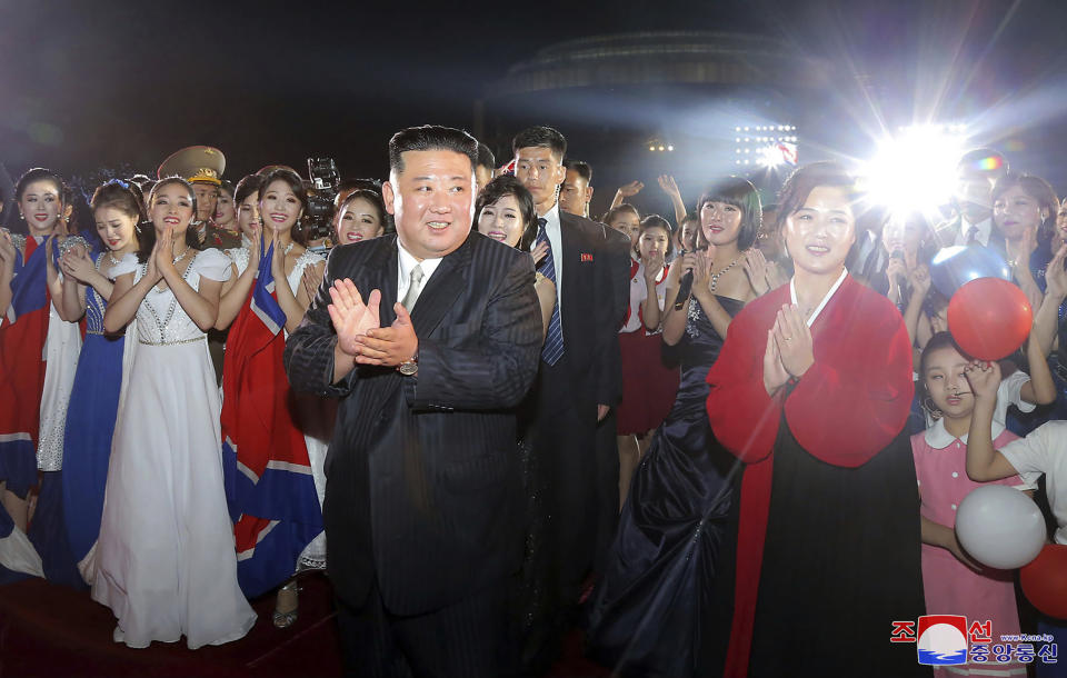This photo provided by the North Korean government shows North Korean leader Kim Jong Un, front left, and his wife Ri Sol Ju, right, meet performers during a celebration marking the nation's 74th anniversary in Pyongyang, North Korea, on Sept. 8, 2022. Independent journalists were not given access to cover the event depicted in this image distributed by the North Korean government. The content of this image is as provided and cannot be independently verified. Korean language watermark on image as provided by source reads: "KCNA" which is the abbreviation for Korean Central News Agency. (Korean Central News Agency/Korea News Service via AP)