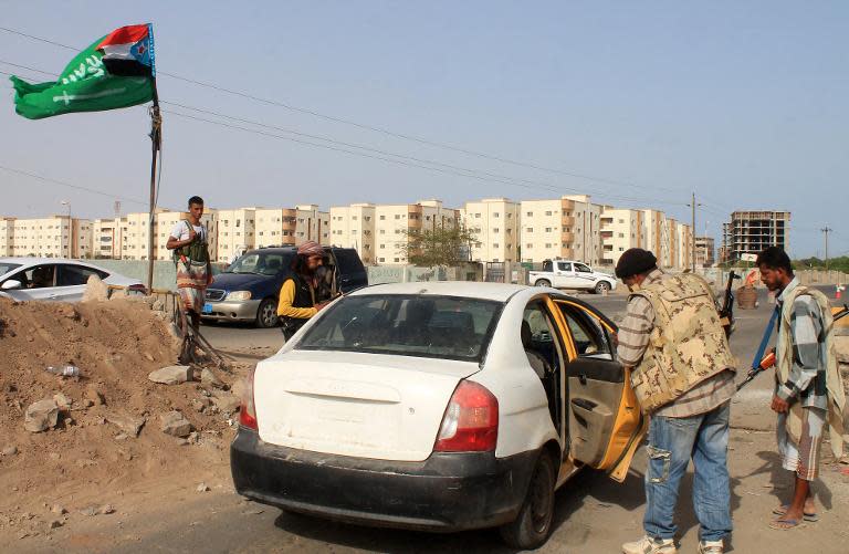 Supporters of the southern separatist movement and the Saudi led-coalition conducting air raids on rebel positions check a vehicle at a checkpoint in Aden on April 7, 2015