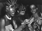 <p>Model Bethann Hardison dons a masquerade mask as she mingles with actress Daniela Morera and fashion designer Stephen Burrows at a party thrown during Studio 54's heyday. </p>