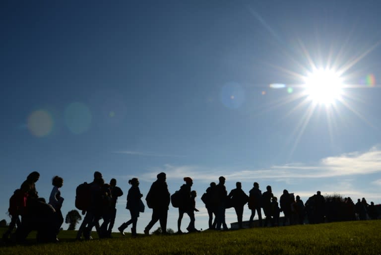 Migrants walk from the Austrian-German border to a registration point near the Bavarian village of Wegscheid in southern Germany, on October 12, 2015